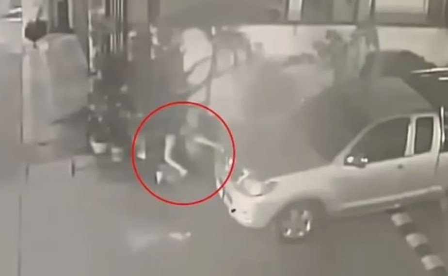 Mulher parindo atrás de um veículo