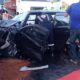 Carro preto amassado após acidente
